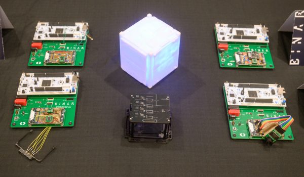 The BinarX High School Student-Designed & Built Payloads for Binar-5 (mounted on green Binar Payload Development Kit boards for testing) next to the Binar-5 Payload Bay (bottom middle of photo)